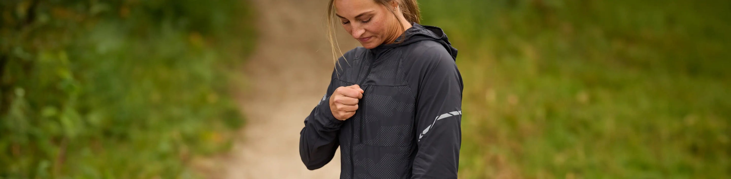 runner wearing a Nathan Sports Stealth Jacket in Black