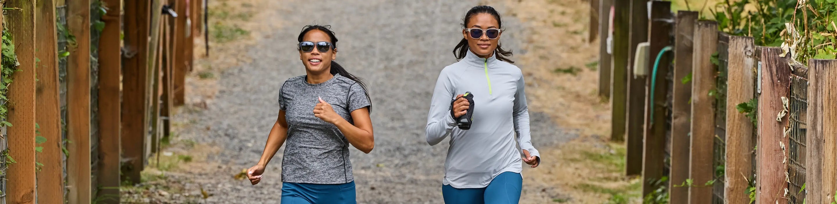 two running on a path in Nathan Sports running apparel and sunglasses