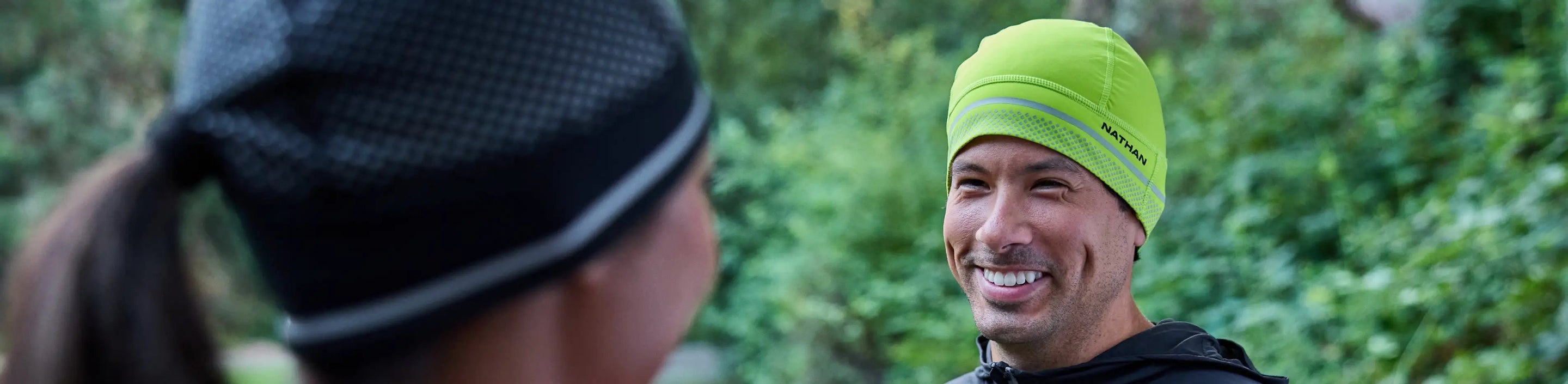 two runners each wearing a Nathan Sports HyperNight Reflective Beanie