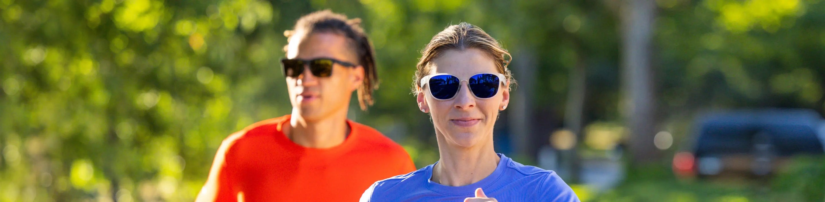 two runners in the sunshine wearing Nathan Sports sunglasses