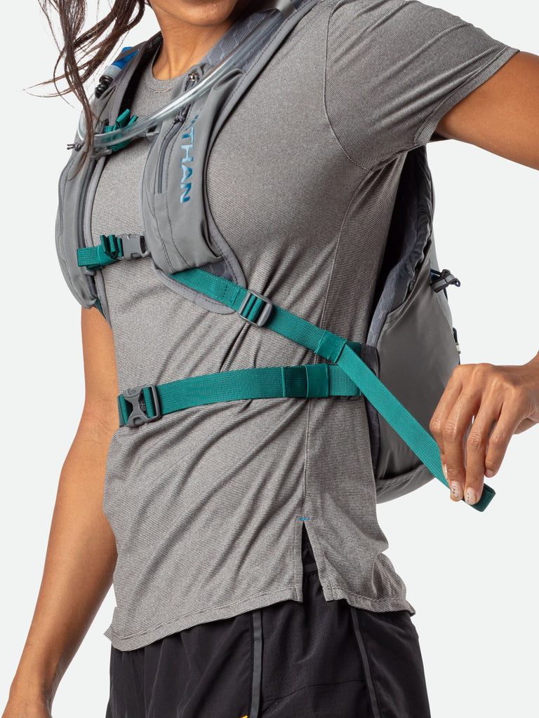 Nathan Crossover 10 Liter Hydration Pack - Charcoal/Marine Blue - On Model - Tightening Straps For Better Fit