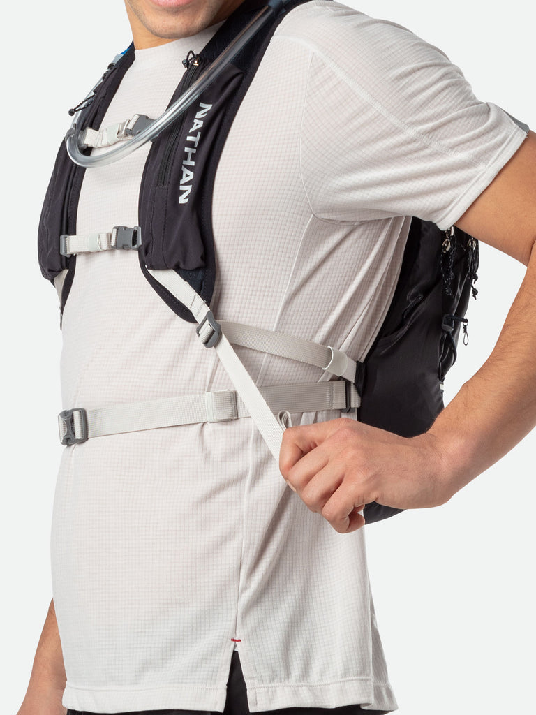 Nathan Crossover 15 Liter Hydration Pack - Black/Vapor Grey - On Model - Tightening Straps For Better Fit