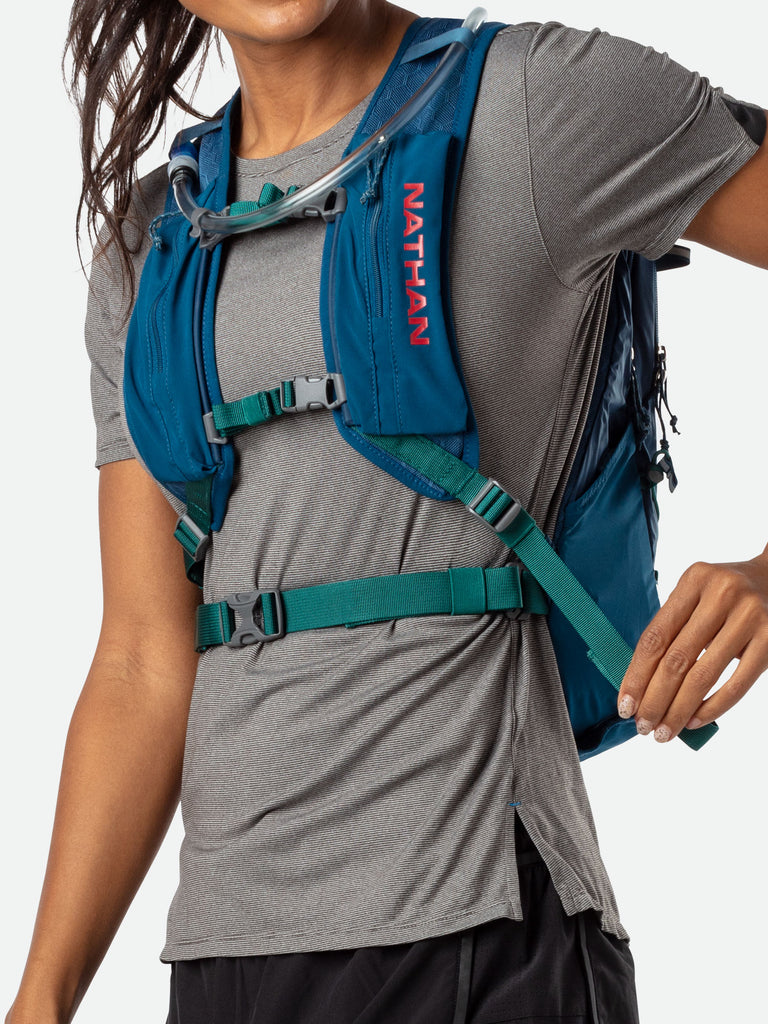 Nathan Crossover 15 Liter Hydration Pack - Marine Blue/Hot Red - On Model - Tightening Straps For Better Fit
