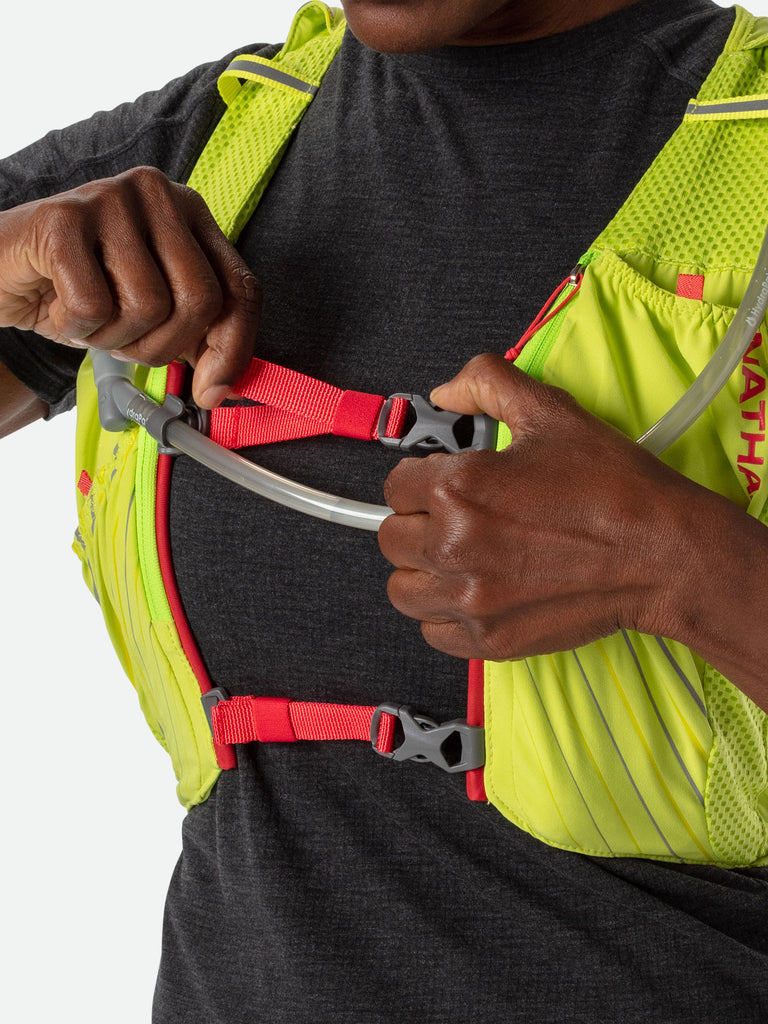 Nathan Pinnacle 12 Liter Women's Hydration Race Vest - Finish Lime/Hibiscus Red - Female Runner Tightening Straps on Vest For Better Fit