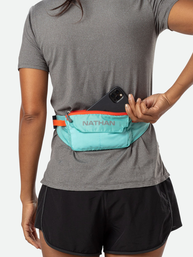 Nathan Marathon Waist Pack - Breeze Blue - On Model - Runner Pulling Out Cell Phone From Pack
