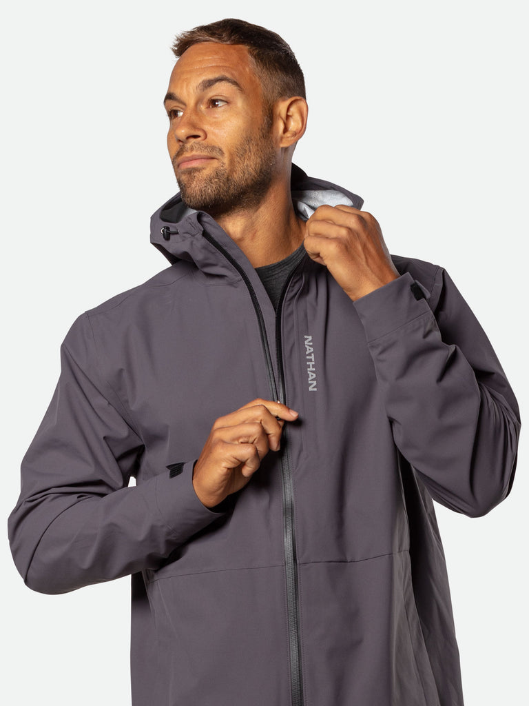 Nathan Men's Protector Rain Jacket – Dark Charcoal - On Model – Pulling Zipper Down on Chest Pocket