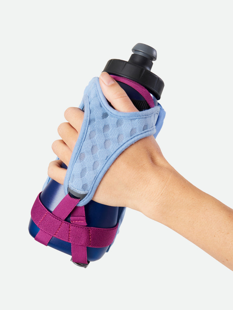 Nathan QuickSqueeze 22oz Hydration Handheld - Perwinkle/Estate Blue - Runner Gripping Handheld Through Strap